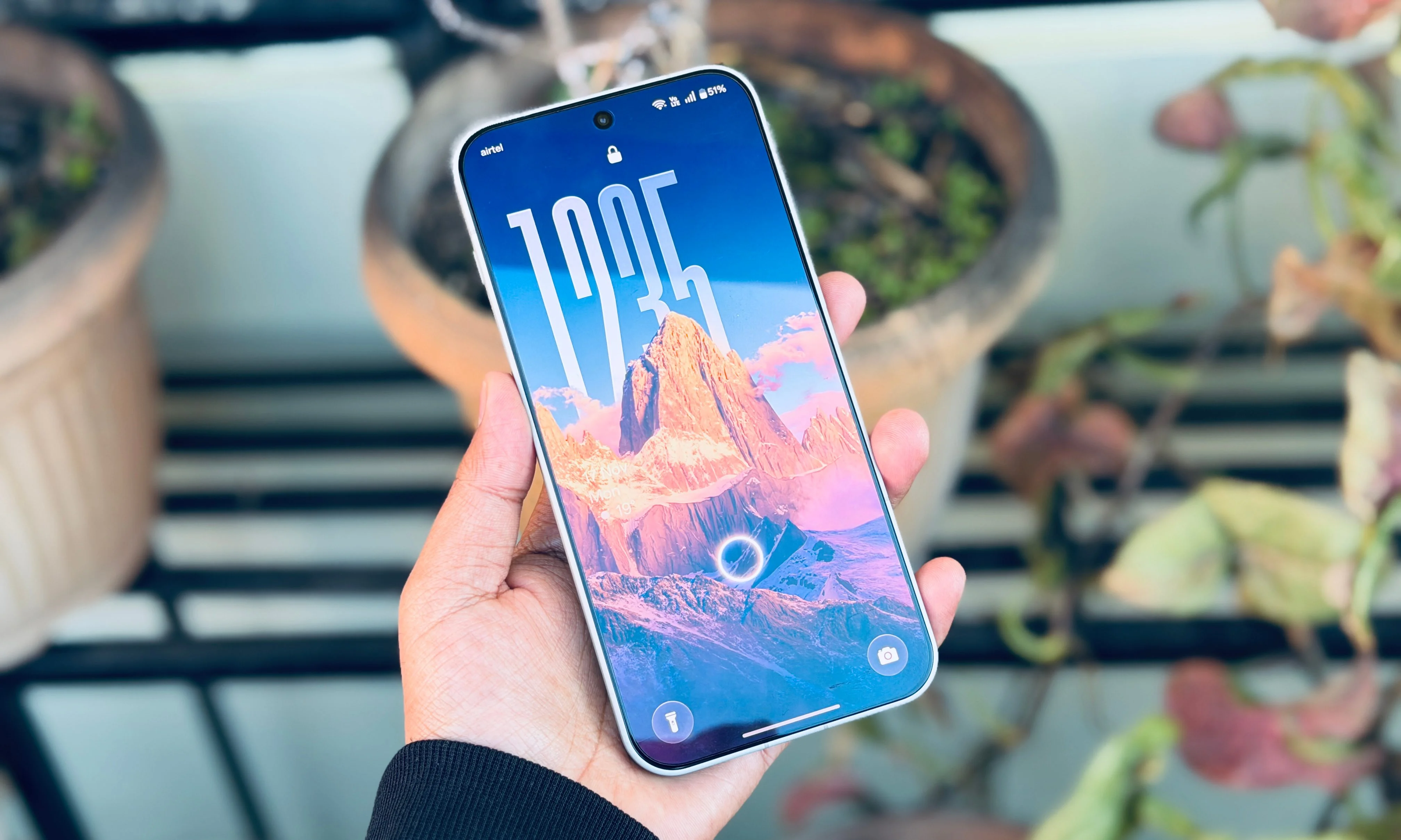 Person holding OnePlus 15.