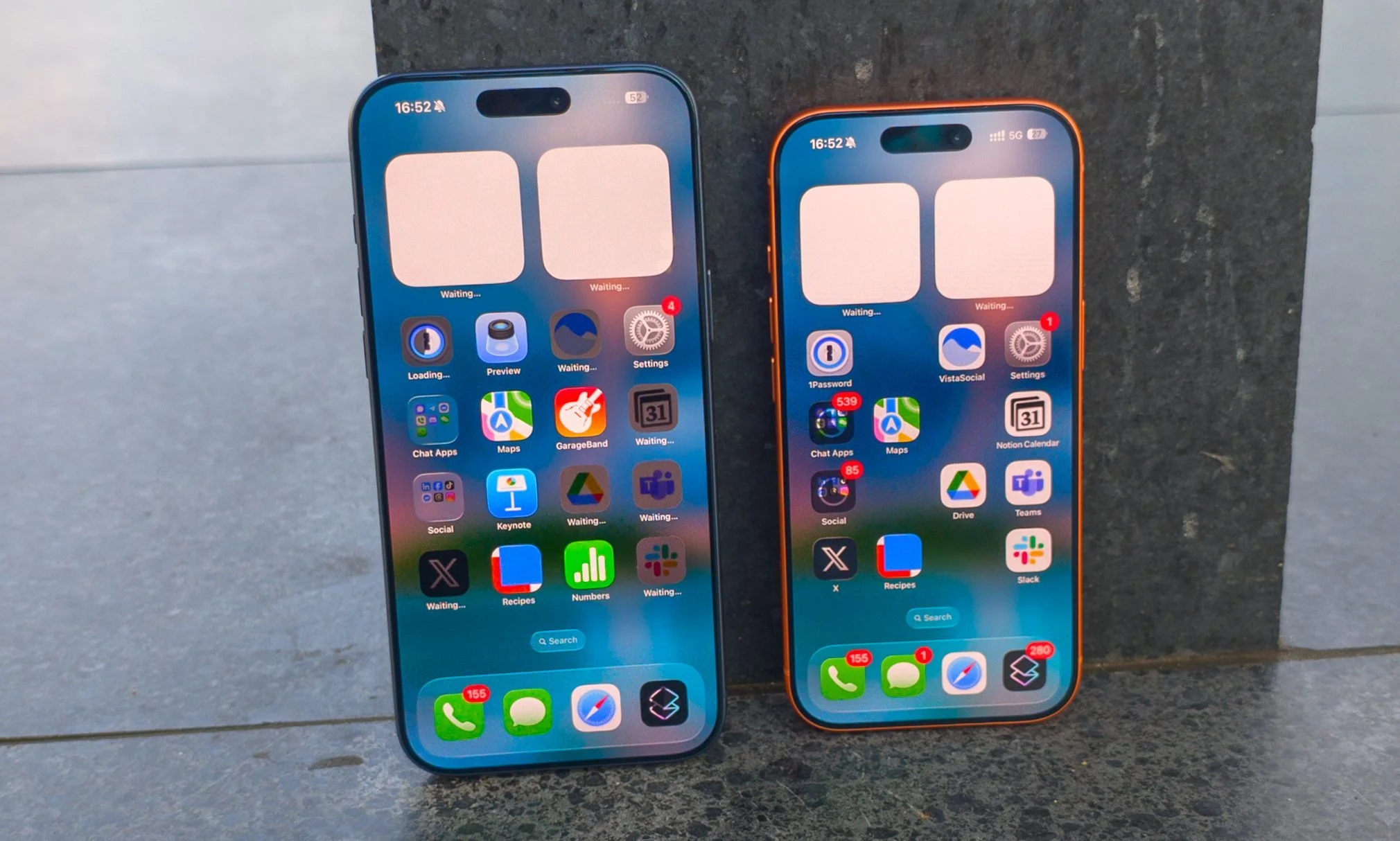 Apple iPhone 17 Pro in Cosmic Orange next to the iPhone 17 Pro Max in Deep Blue