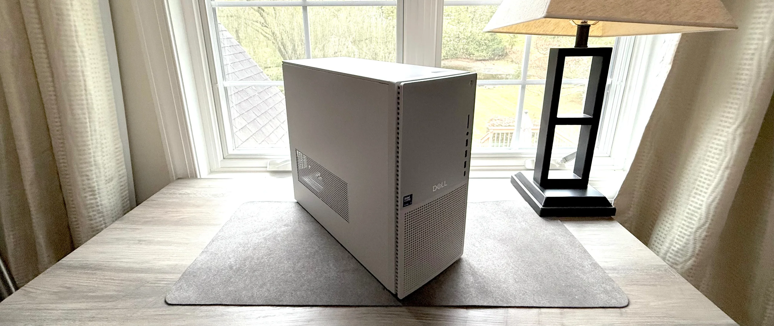 Dell Tower Plus resting on a desktop in front of a window