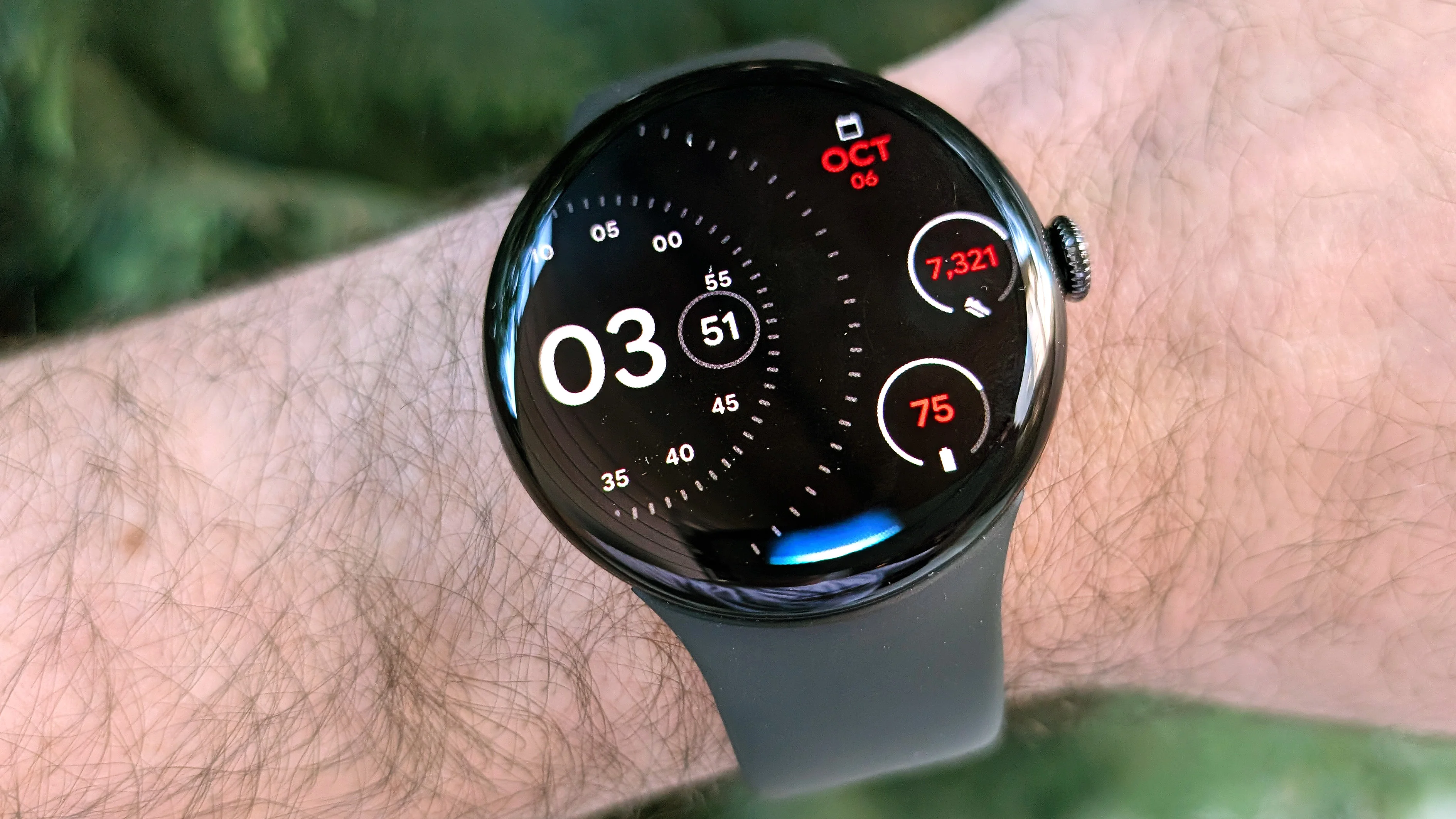 Close-up of the Google Pixel Watch 4 in black on a black strap