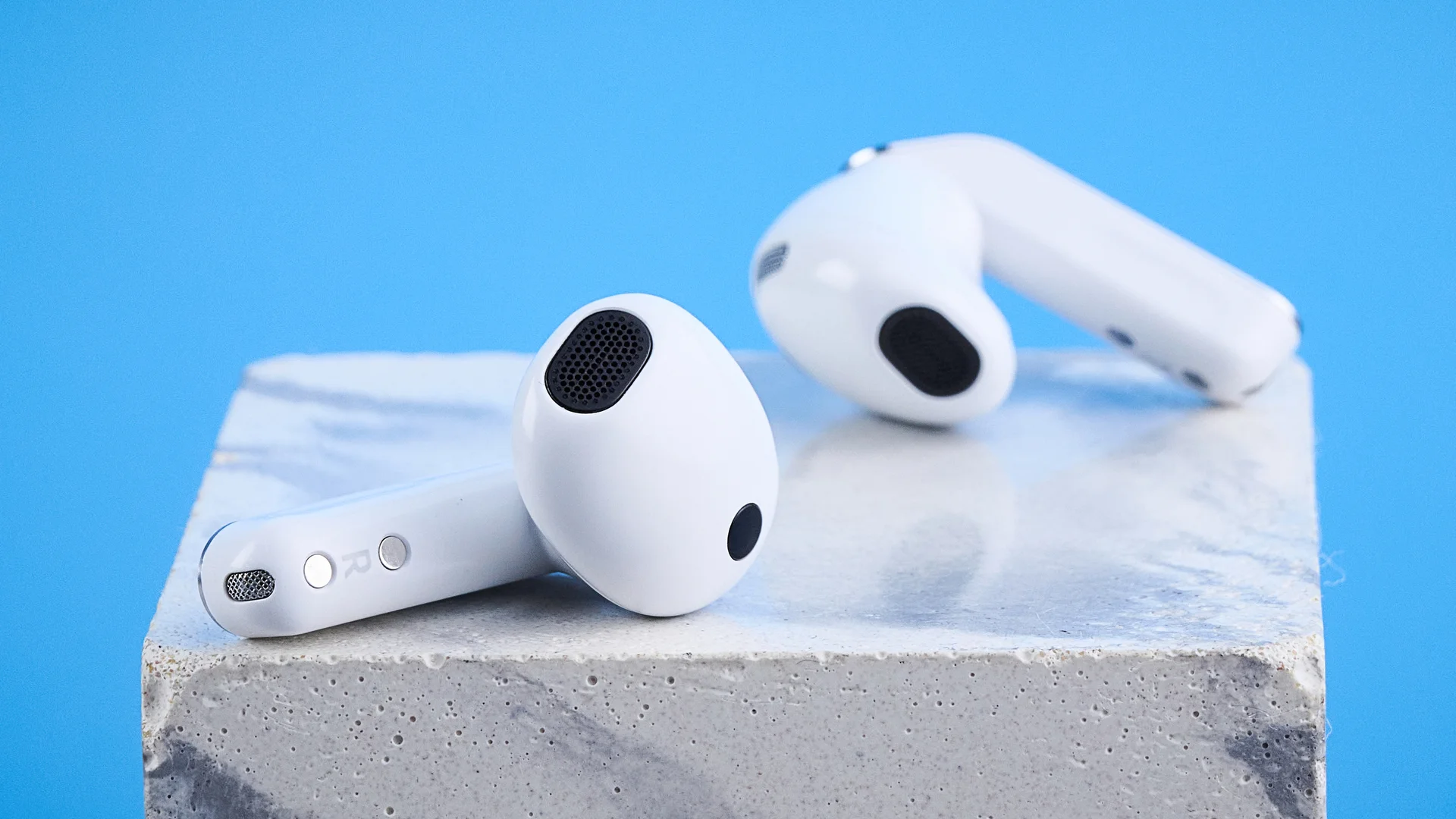 the samsung galaxy buds 4 photographed against the blue tom's guide background showing charging case and buds