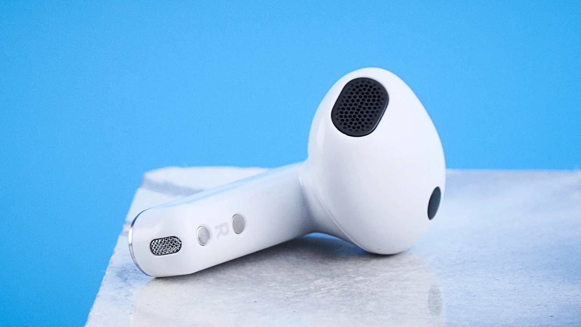 the samsung galaxy buds 4 photographed against the blue tom's guide background showing charging case and buds