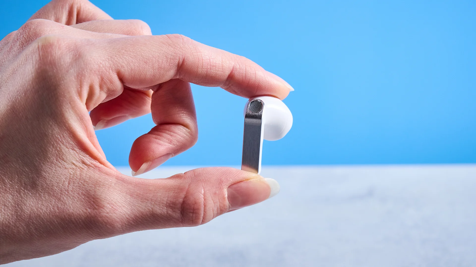the samsung galaxy buds 4 photographed against the blue tom's guide background showing charging case and buds