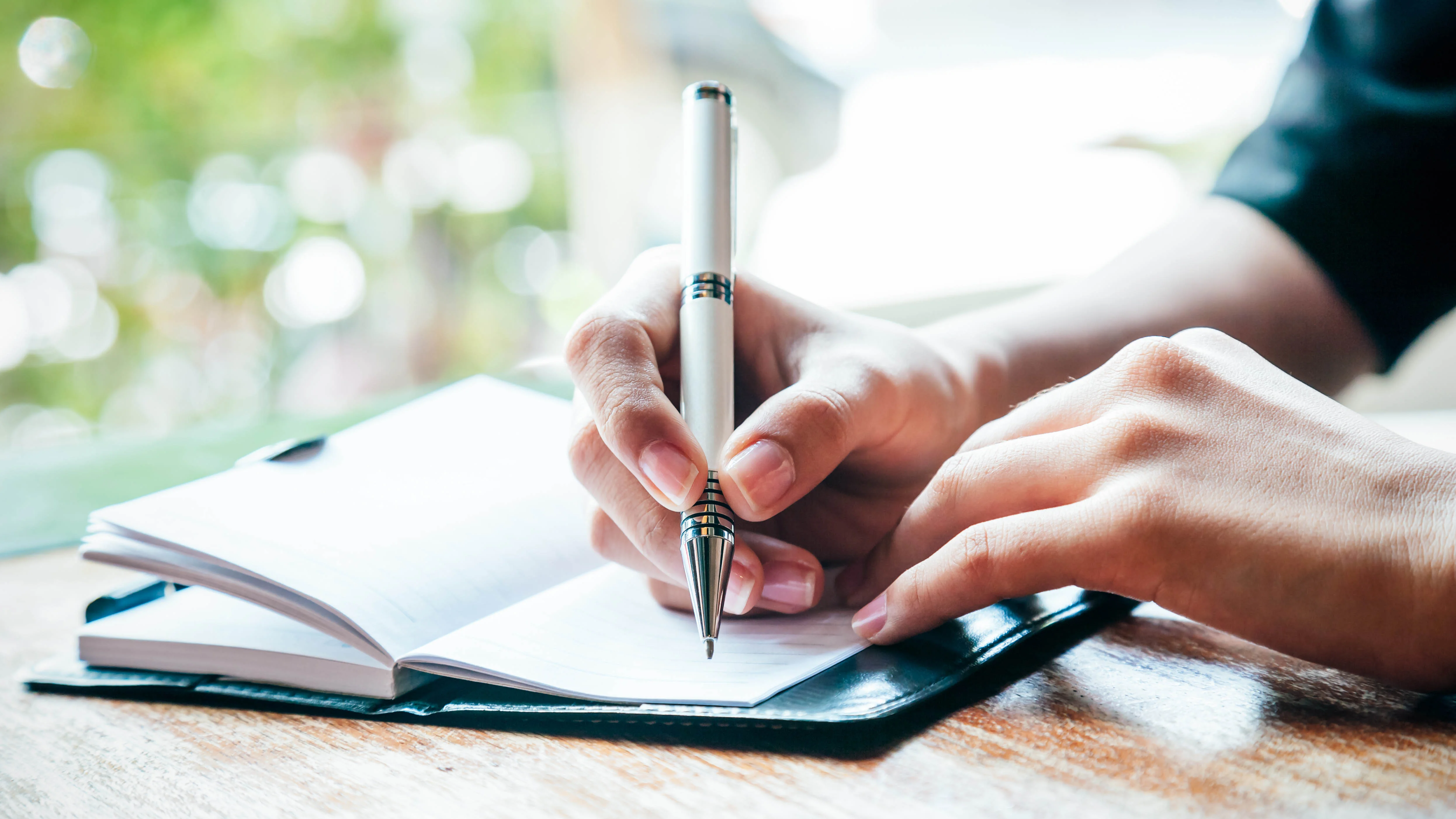 Someone writing in a journal